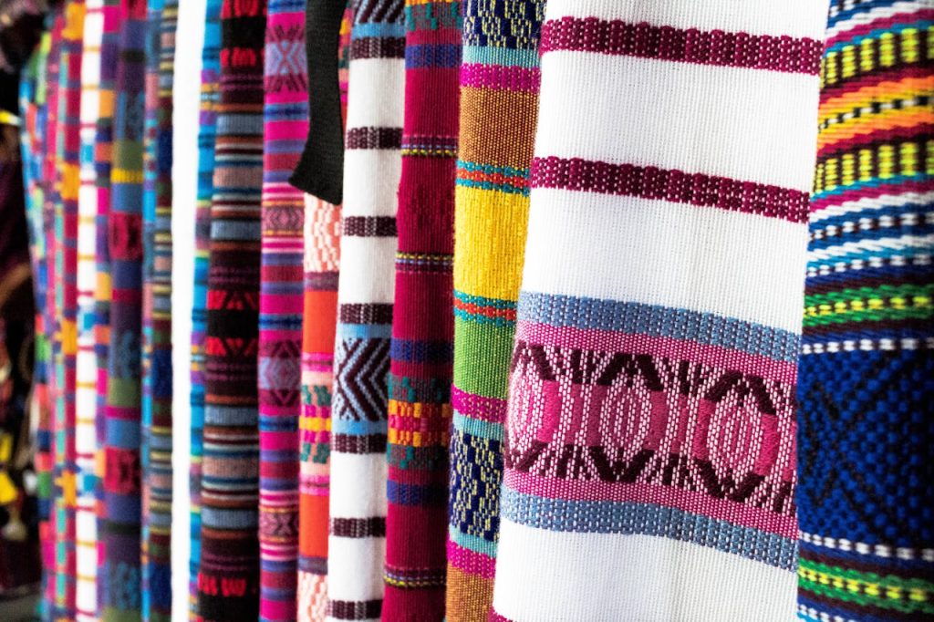 pexels-photo-2928381 Vibrant woven fabrics showcasing traditional patterns in Antigua Guatemala market.